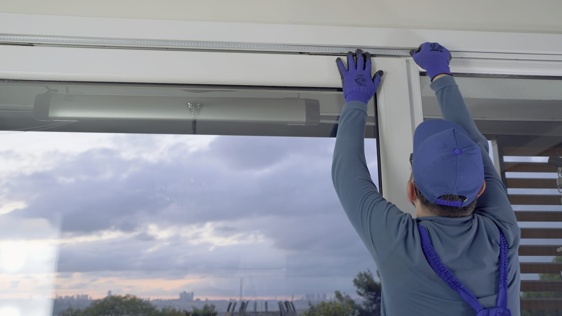 Professional installer fitting premium window coverings for a clean, precise finish