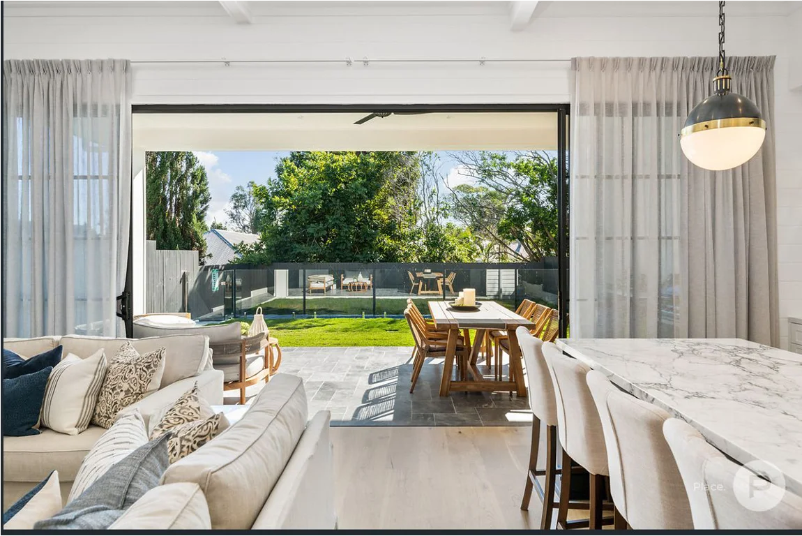 Two pinch pleat sheer curtains in a bright living area - Camp Hill