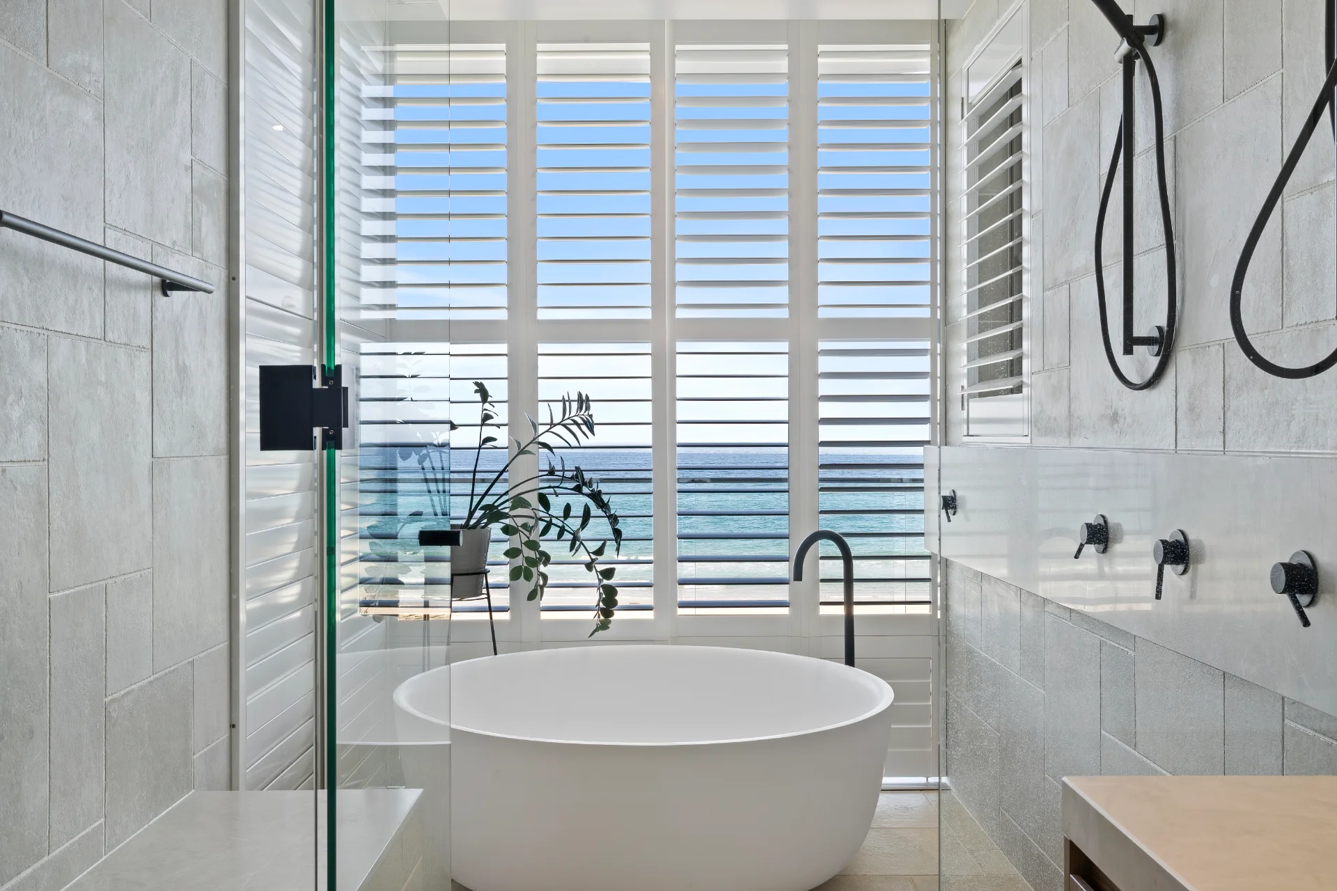 Tier-on-tier plantation shutters in a Brisbane bathroom - suited to humidity and coastal conditions